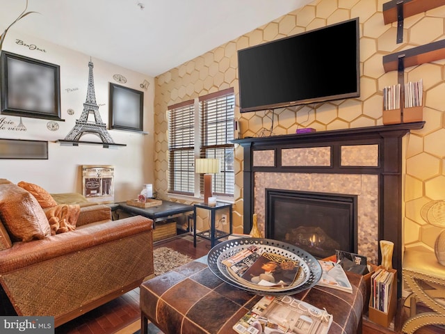 living area with wood finished floors and a tile fireplace