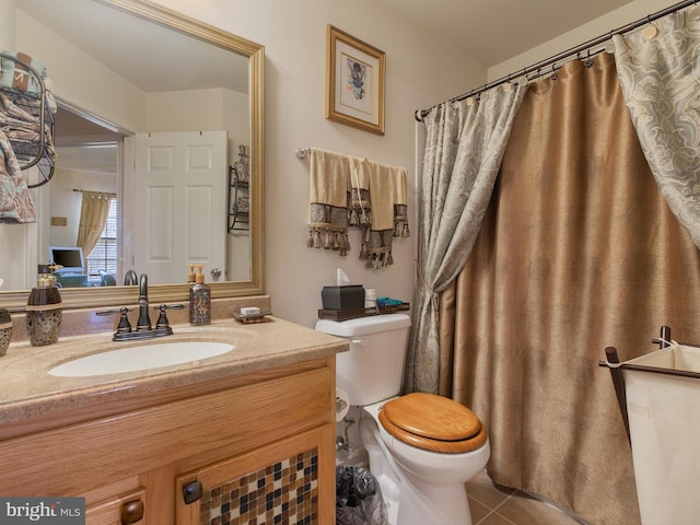 bathroom featuring vanity, tile patterned floors, and toilet