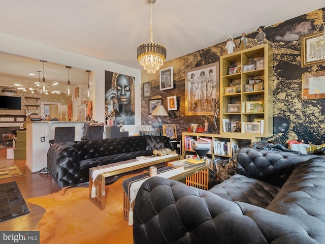 living room with a notable chandelier and wood finished floors