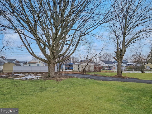 view of yard with a residential view and fence