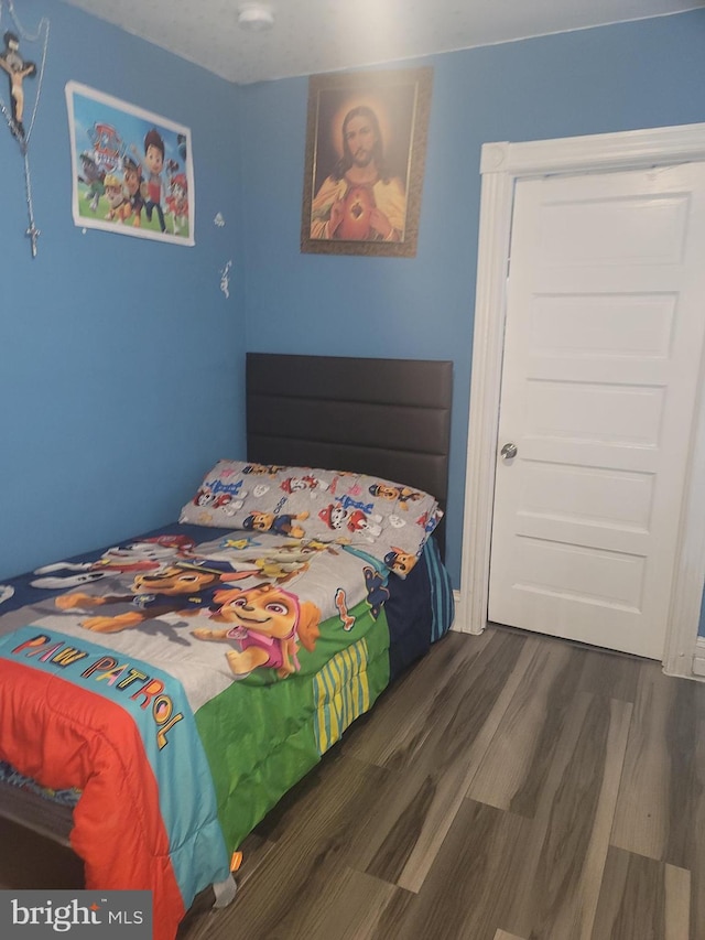 bedroom featuring dark wood-type flooring