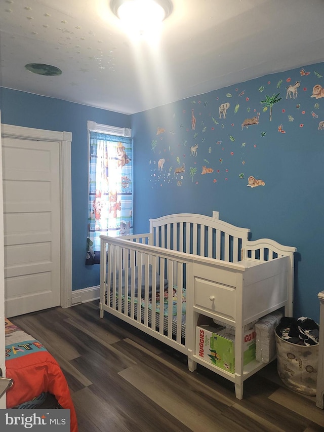 bedroom with baseboards and wood finished floors