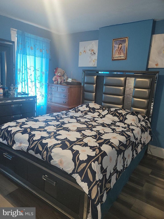 bedroom with wood finished floors