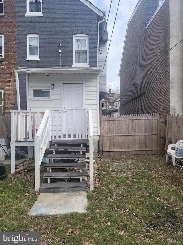 back of property with fence and brick siding