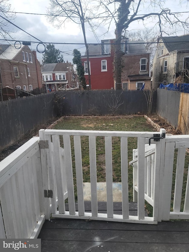 view of yard with a fenced backyard and a residential view