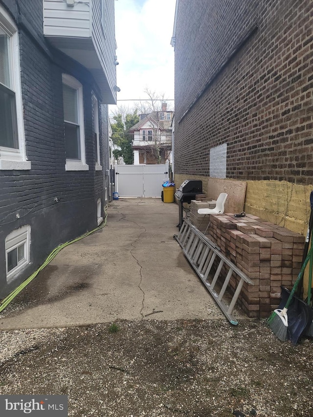 view of patio / terrace with a grill and fence