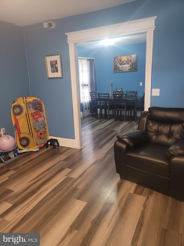 living room with baseboards and wood finished floors