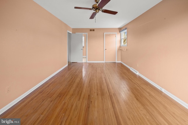 unfurnished bedroom with visible vents, light wood-style flooring, and baseboards