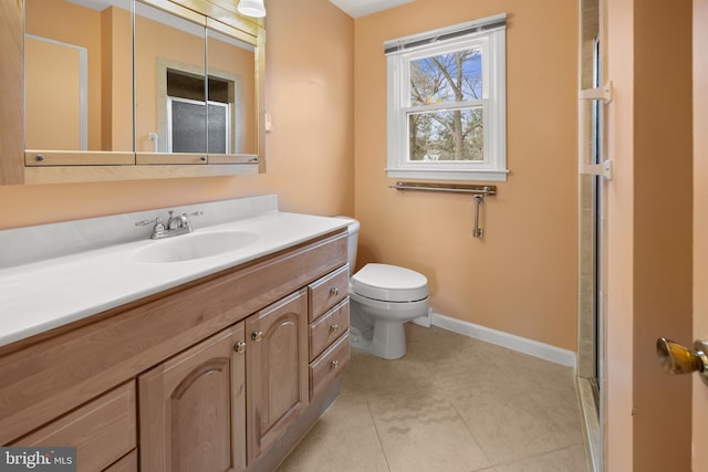 bathroom featuring toilet, vanity, baseboards, tile patterned floors, and an enclosed shower