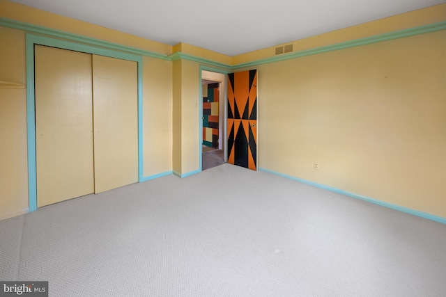 unfurnished bedroom with carpet, visible vents, and baseboards