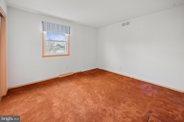 carpeted empty room with baseboards and visible vents