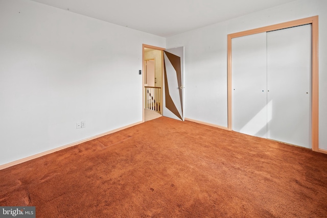 unfurnished bedroom featuring carpet floors and a closet