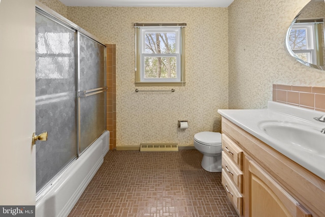 bathroom with toilet, visible vents, and wallpapered walls