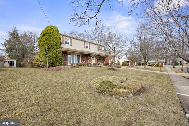 traditional-style home with a front lawn and brick siding