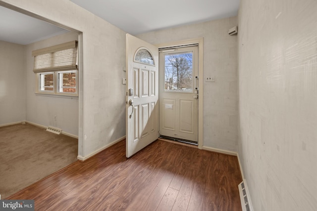 foyer with wood-type flooring, visible vents, and a wealth of natural light