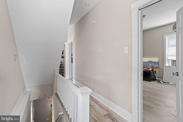 stairs featuring wood finished floors and baseboards