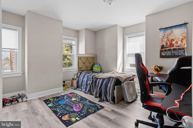 bedroom featuring wood finished floors and baseboards