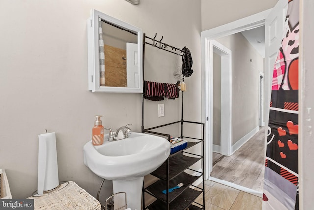 bathroom featuring baseboards and wood finished floors