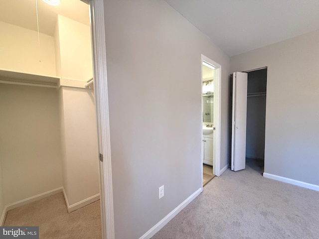 unfurnished bedroom featuring carpet, a closet, and baseboards