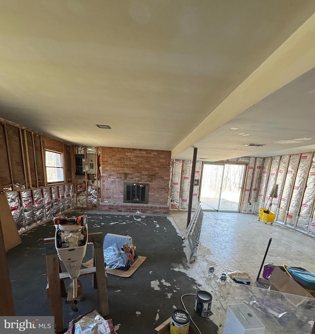 misc room featuring a brick fireplace and a healthy amount of sunlight