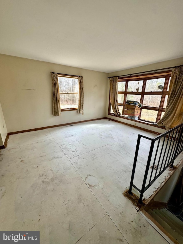 interior space featuring baseboards and stairs