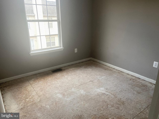 empty room with visible vents and baseboards