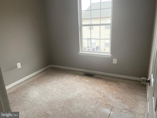 empty room featuring visible vents and baseboards