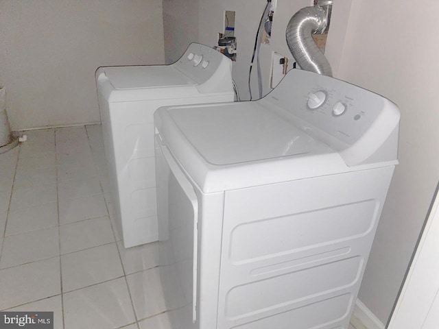 washroom with washer and dryer, laundry area, baseboards, and tile patterned floors