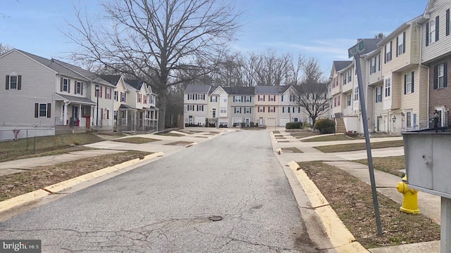 view of road with a residential view, curbs, and sidewalks