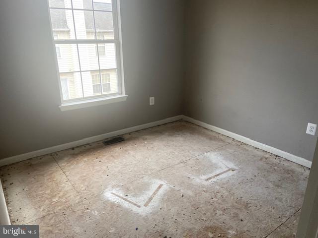 empty room featuring visible vents and baseboards