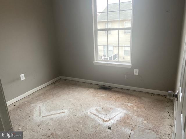 empty room featuring baseboards