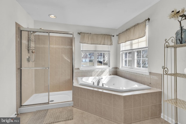 bathroom featuring tile patterned floors, a stall shower, and a whirlpool tub