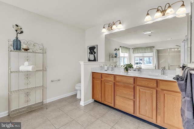 full bath with tile patterned flooring, double vanity, toilet, and a sink