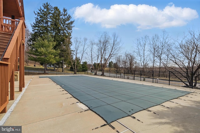 community pool featuring a patio and fence