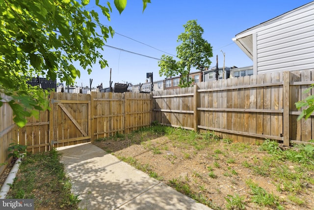 view of yard with fence and a gate