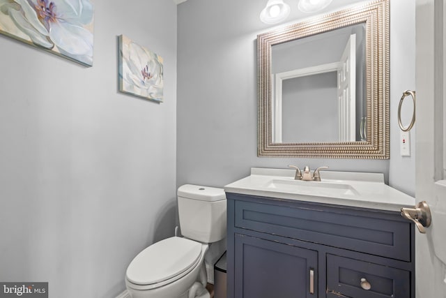 half bath featuring toilet and vanity