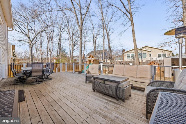 wooden deck featuring outdoor dining area, a fenced backyard, and an outdoor hangout area