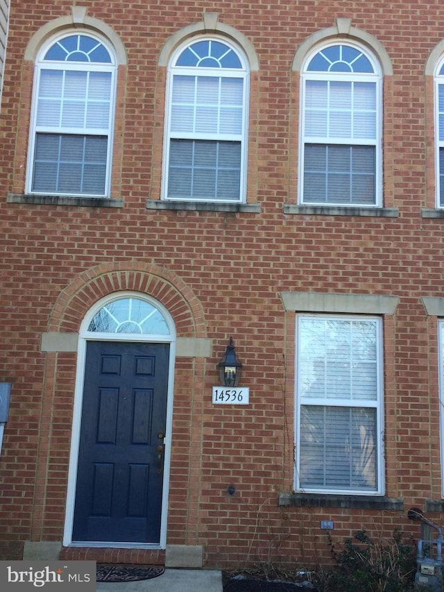 property entrance with brick siding