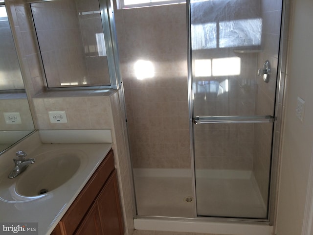 full bathroom featuring tasteful backsplash, a shower stall, and vanity