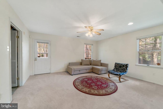 living room featuring carpet, visible vents, and baseboards