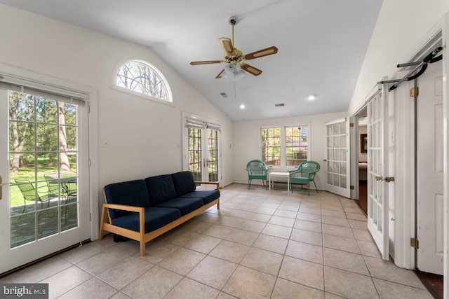 living area featuring a ceiling fan, a wealth of natural light, light tile patterned flooring, and visible vents