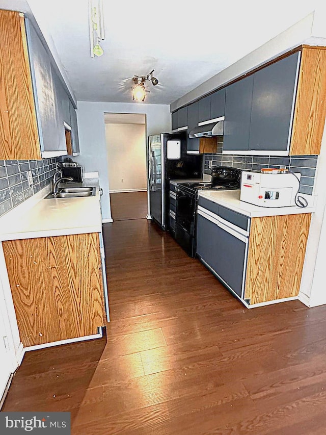 kitchen featuring dark wood finished floors, black range with electric stovetop, backsplash, smart refrigerator, and under cabinet range hood