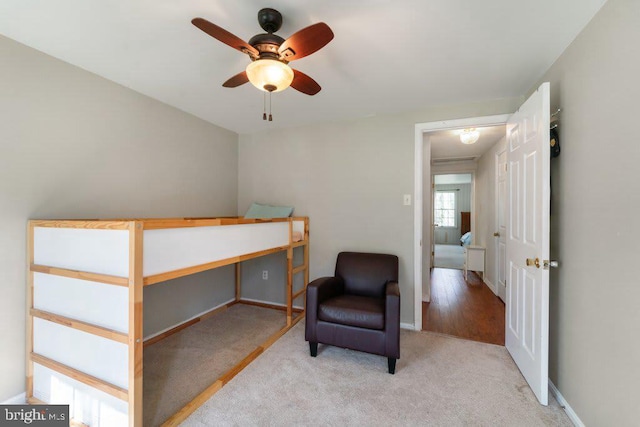 carpeted bedroom with a ceiling fan and baseboards