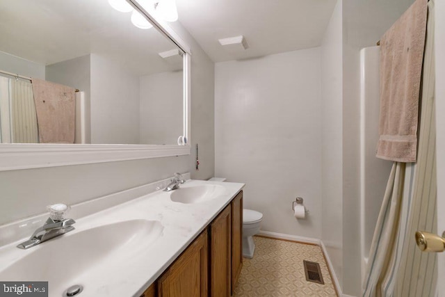 full bathroom with toilet, double vanity, visible vents, and a sink