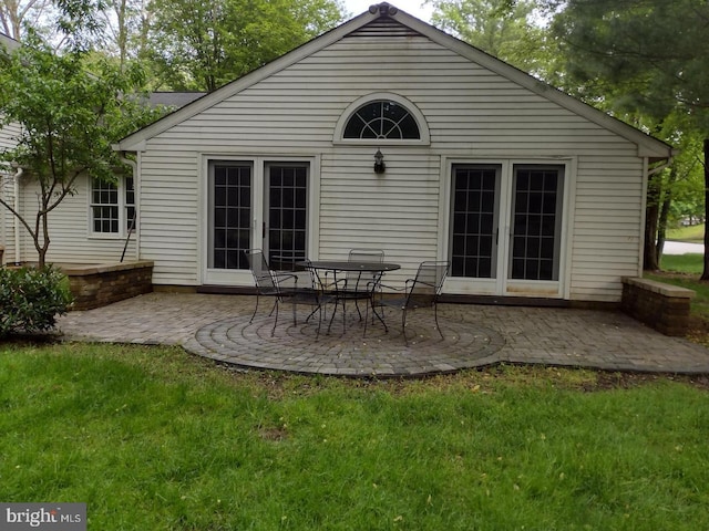 back of house featuring a yard, french doors, and a patio area