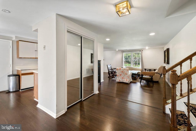 living area featuring dark wood-style floors, baseboards, stairway, and recessed lighting