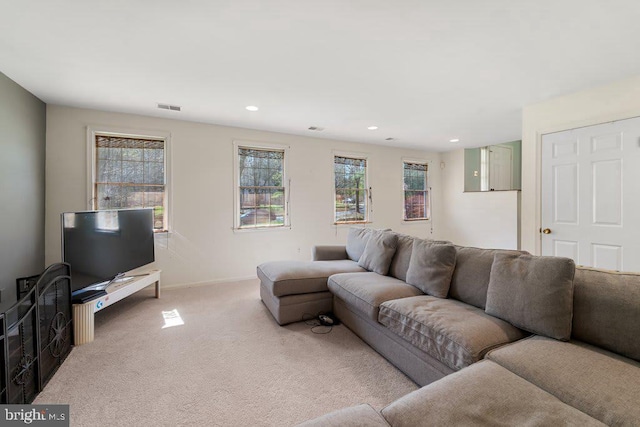 carpeted living area with plenty of natural light, visible vents, baseboards, and recessed lighting