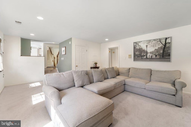 living area featuring stairway, recessed lighting, light colored carpet, and visible vents