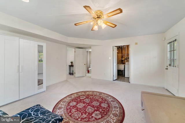 interior space featuring carpet flooring, a sink, ensuite bath, and ceiling fan