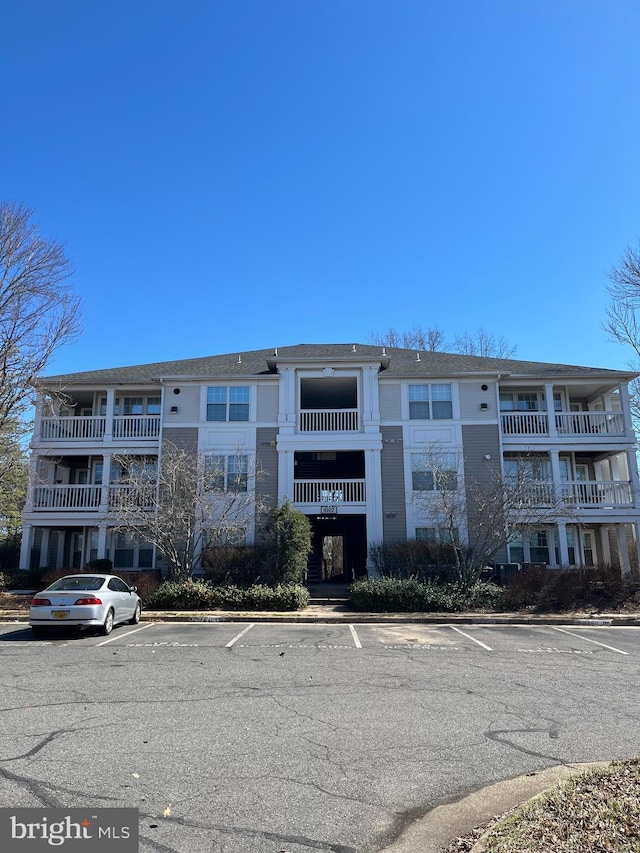 view of property featuring uncovered parking